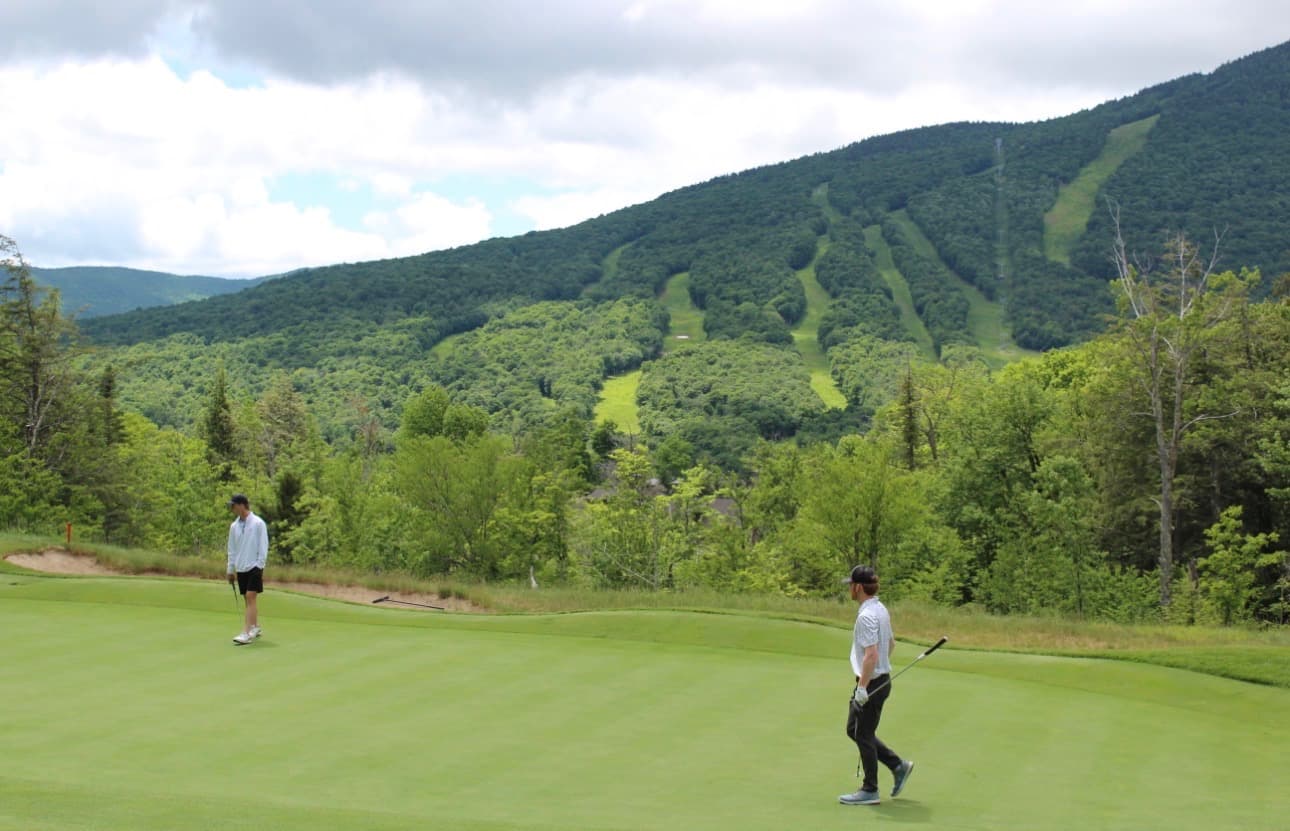 Golfers competing on a mountain course